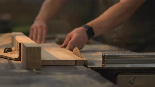 Woodworker Using Table Saw to Cut Lumber