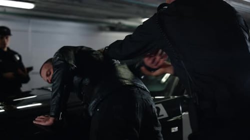 Man in Handcuffs Arrested by Police at Night