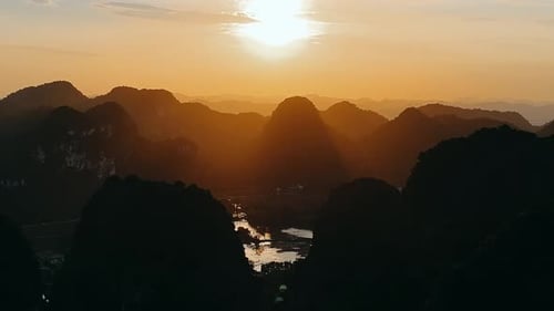 Sunrise Over Silhouetted Mountain Peaks and Valley