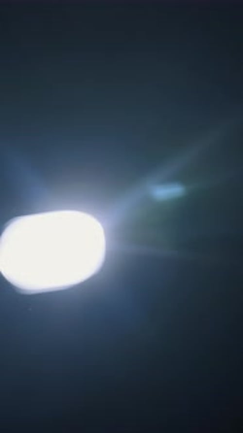 Bright White Light Moving In Dark With Abstract Lens Flare Glare
