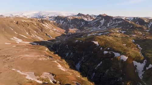 Sunrise panorama aerial view mountain peaks in Iceland, brown landscape