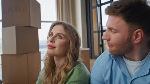 Tired Couple Moving House Sitting Modern Apartment Between Carton Boxes Closeup