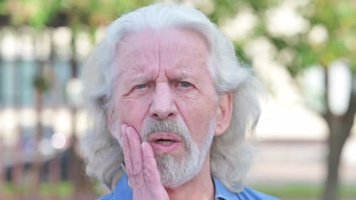 Close up of Old Man with Toothache