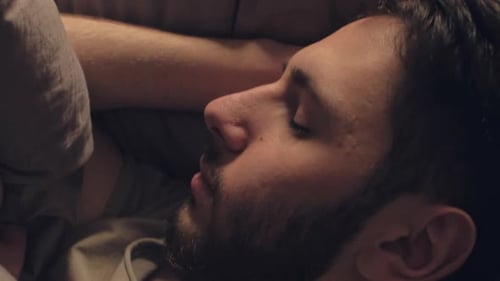 Man Sleeping Peacefully in Bed at Night