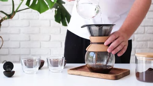 Man prepares coffee in style pour over