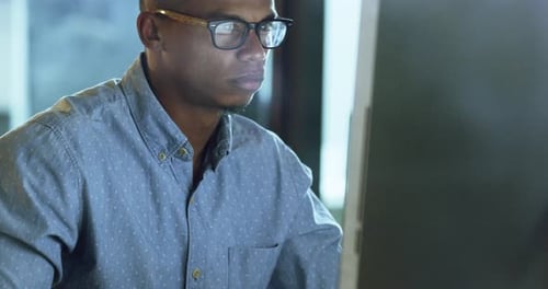 4k video footage of a young businessman working late on a computer in an office
