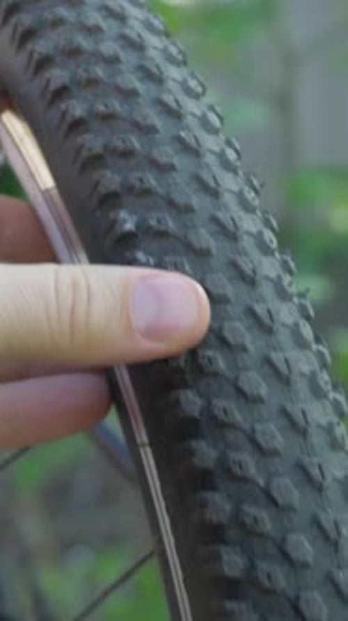Close Up of Mountain Bike Tire Being Inspected