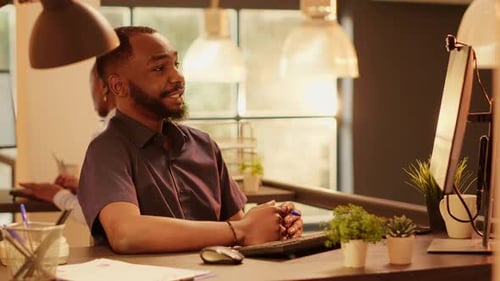 Man Video Conferencing in Office Environment