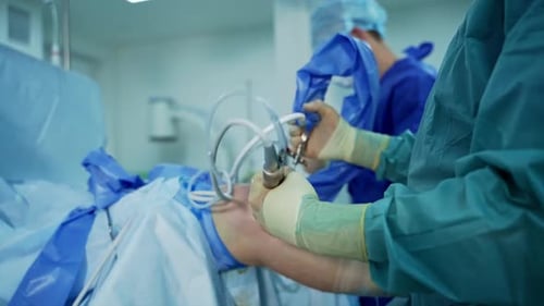 Process of trauma surgery operation. Group of surgeons in operating room with surgery equipment.