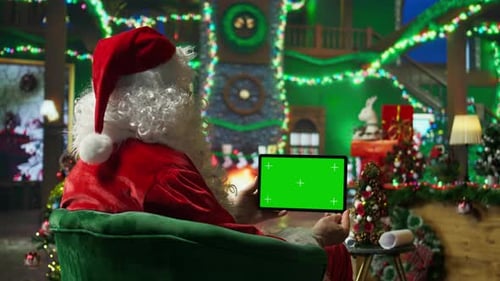 Santa Claus Reads Letters From Kids on Green Screen Tablet