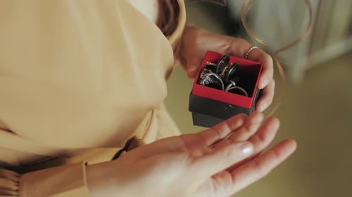 Woman examines rings in a jewelry box