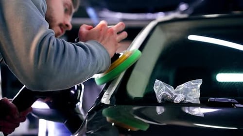 the Car Mechanic at a Service Station Doing the Final Polishing to Shine