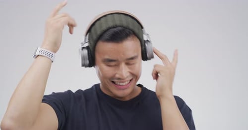 Man Wearing Headphones Listening and Dancing to Music