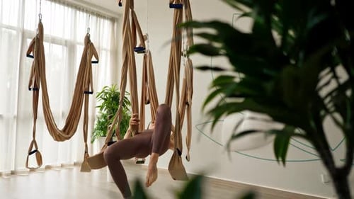 Woman Inverts in Aerial Yoga Hammock for Splits