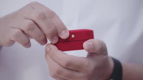 Hands Open Ring Box with Wedding Bands Inside