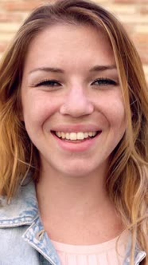 Blond Woman Smiling Cheerfully at Camera, Close Up