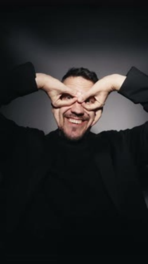 Silly Man Laughs, Makes Faces, Looks at Camera