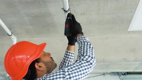 Indian Young Worker Installs Air Conditioner in the Office