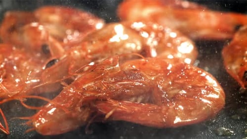 The Shrimp is Fried in a Pan with a Splash Filmed on a Highspeed Camera at 1000 Fps