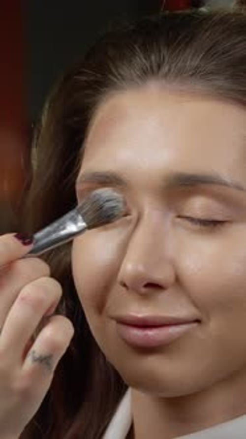 Makeup Artist Applies Makeup to a Young Woman