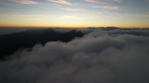 Mountains Rise Above Clouds at Colorful Sunrise