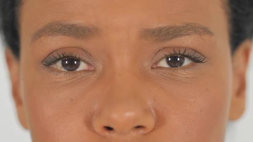 Close up of Female Blinking Eyes on White Background