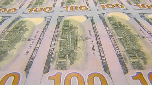 SHEET OF 100 DOLLAR BILLS MOVING TOWARDS CAMERA
