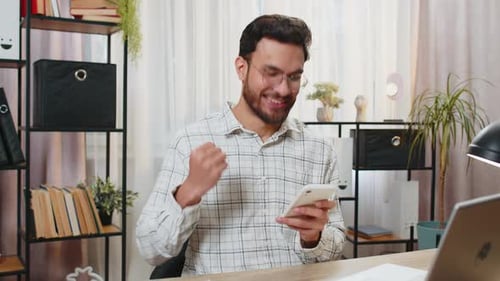 Happy Indian Businessman Using Smartphone Celebrating Success Victory Winning Lottery Casino Jackpot