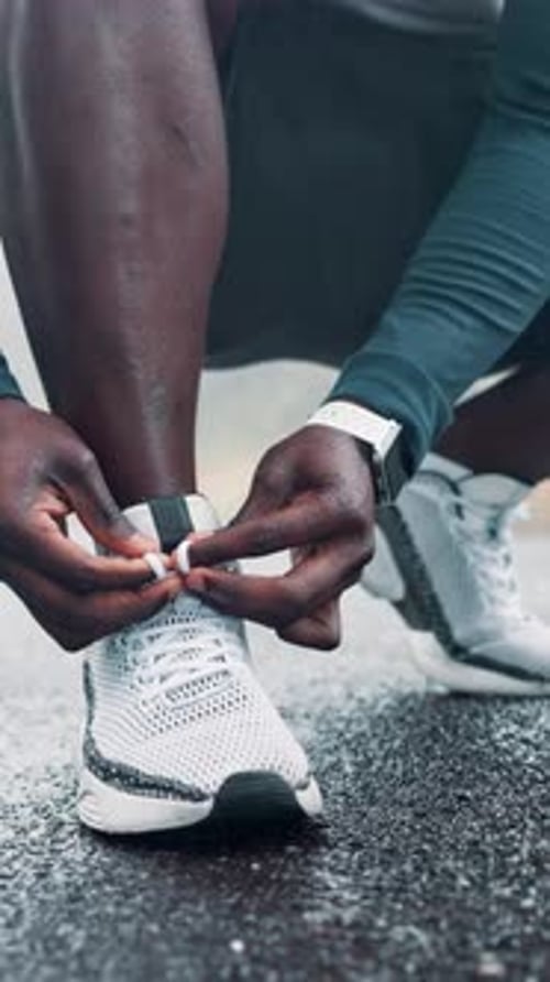 Person, hands or runner with shoe tie on road for workout preparation, exercise or outdoor training