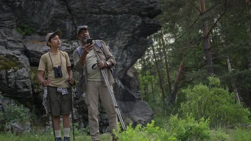 Hikers Exploring Nature with a Smartphone Guide