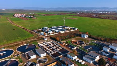 Flight over the water treatment plant with numerous reservoirs.