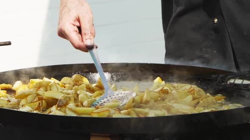 Potatoes Cooking in a Large Frying Pan