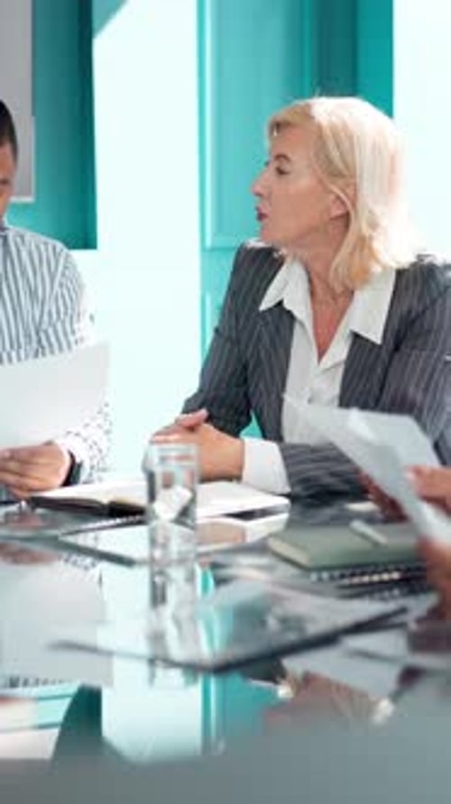 Woman, meeting and talking with documents in office for accounting with data analysis