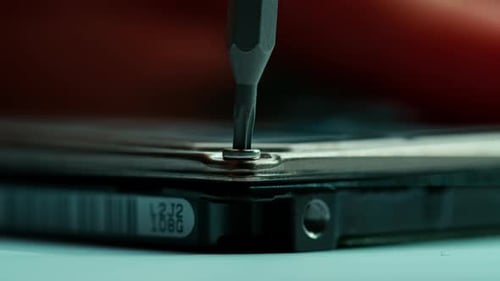 Screwdriver Removes Screw on Corner of Electronic Device