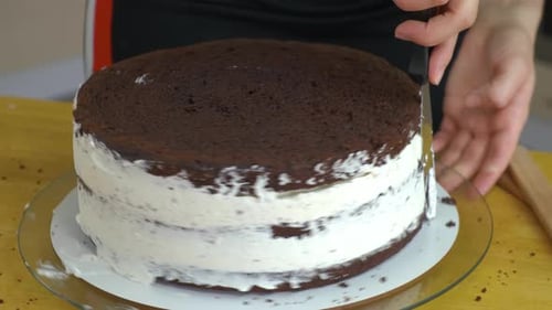Close Up of Woman Hands Making Sweet Cake with White Cream and Biscuit