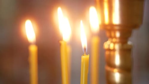 Flames of the Candles in a Church Sways by the Draft