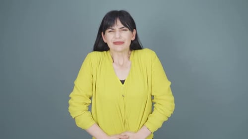 Woman experiencing stomachache.