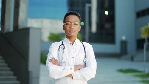 Confident Medical Professional Standing Near Building in Daylight