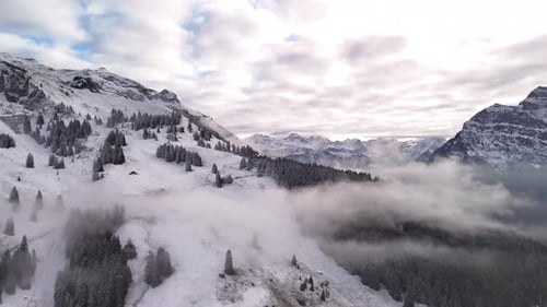 Fronalpstock mountains valley Glarus Alps alpine Switzerland drone snow covered view