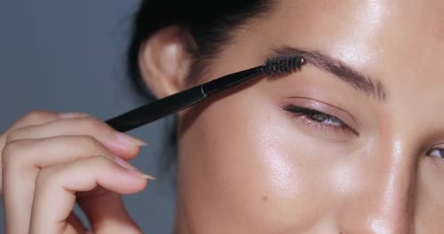 Woman Styling Eyebrows With Brush Close Up