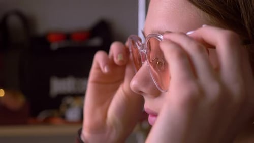 Young Person Puts On Trendy Glasses Close Up