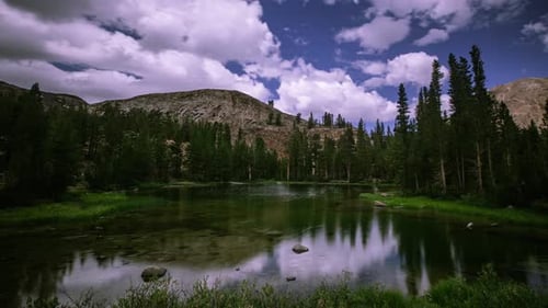 Time Lapse - Beautiful Cloudscape over the Mountain Range with Meadow - 4K