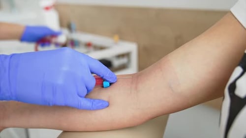 Global vaccination campaign. Woman getting intravenous meds injection at clinic.