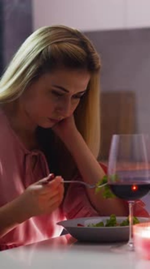 Sad Woman Picks at Food Suffering From Unsuccessful Date