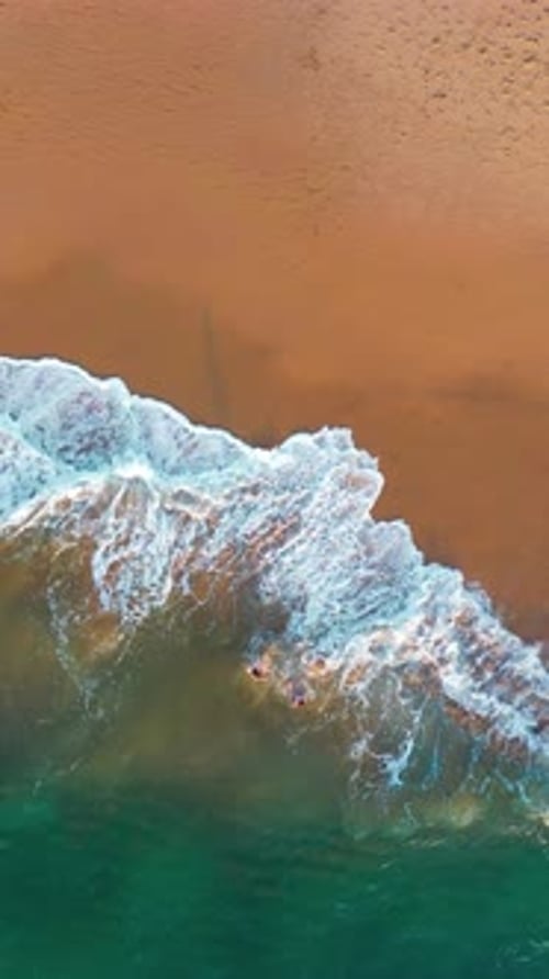 Aerial View of Sea Waves on Sandy Beach