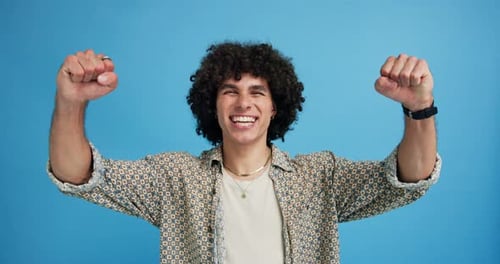 Fist pump, winner and face of man in studio for achievement, success and reward