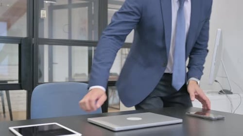 Mature Adult Businessman Coming to Office Desk