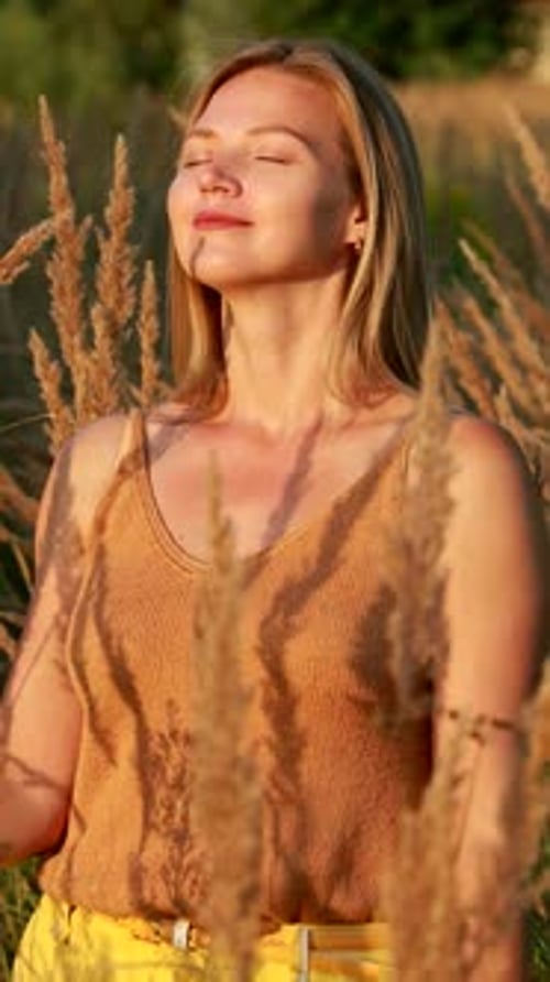 Woman Enjoying Golden Hour in Rural Field