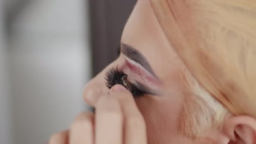 Close up Applying False Eyelashes with Dramatic Makeup