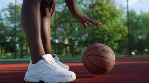 Athletic Person Dribbles Basketball on Urban Court